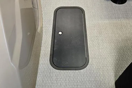 Slide: The Image of Floor compartment in 2026 Evotti 521QL, featuring a sleek black cover on textured surface. - 7
