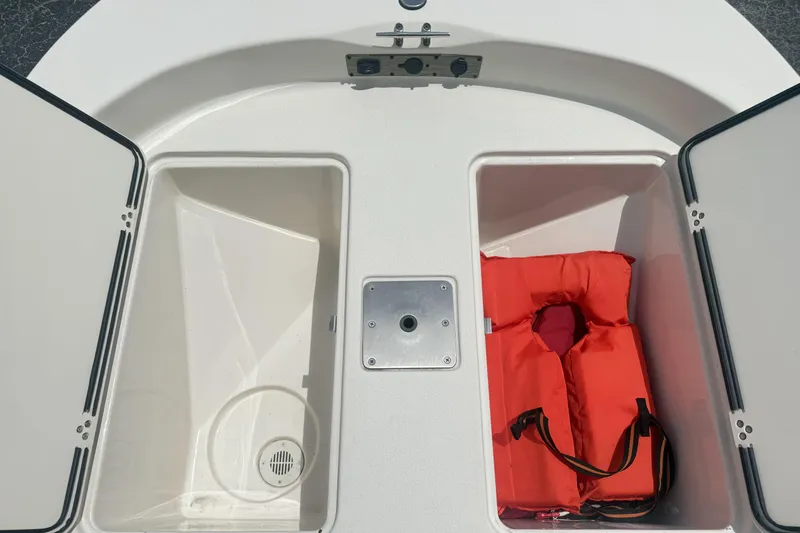 Slide: The Image of 2023 Carolina Skiff 162 JLS storage compartments with life jacket. - 6
