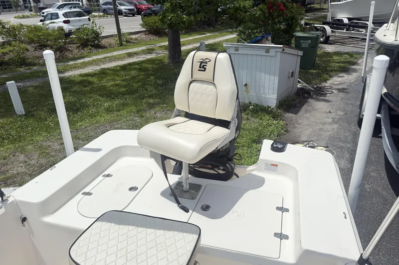 Slide: The Image of 2023 Carolina Skiff 162 JLS boat seat and deck, parked outdoors. - 8
