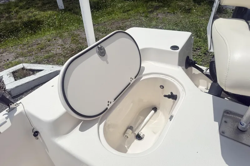 Slide: The Image of 2023 Carolina Skiff 162 JLS boat with open storage compartment on deck. - 9
