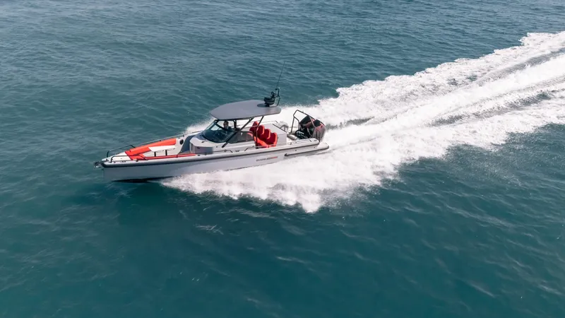 Slide: The Image of 2023 BRABUS Shadow 500 T-Top boat cruising on open water. - 2