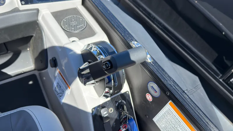 Slide: The Image of Close-up of throttle lever on a 2025 Barletta C22U boat. - 23