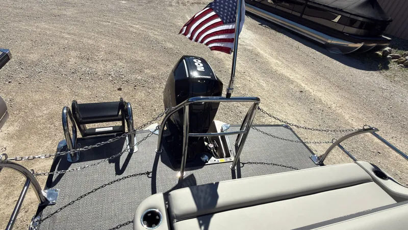 Slide: The Image of Barletta C22U 2025 pontoon boat with outboard motor and American flag. - 30