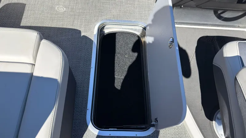 Slide: The Image of Open storage compartment on a 2025 Barletta C22U boat. - 31
