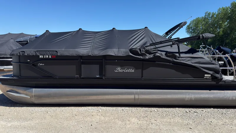 Slide: The Image of 2025 Barletta C22U pontoon boat with cover on dry ground. - 33