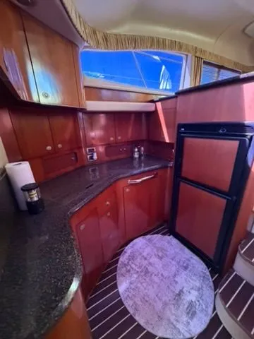 Slide: The Image of Interior of 2005 Sea Ray 390 Motor Yacht featuring elegant kitchen. - 15