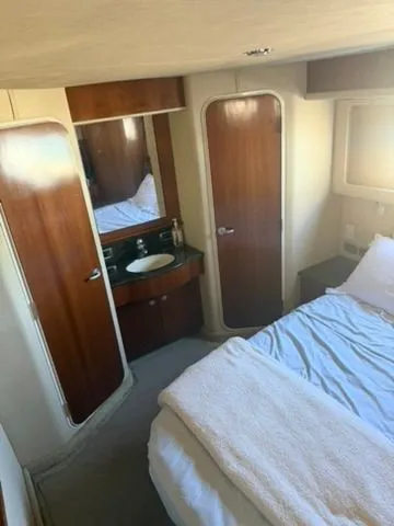 Slide: The Image of Interior of 2005 Sea Ray 390 Motor Yacht, bedroom with bed and sink. - 18