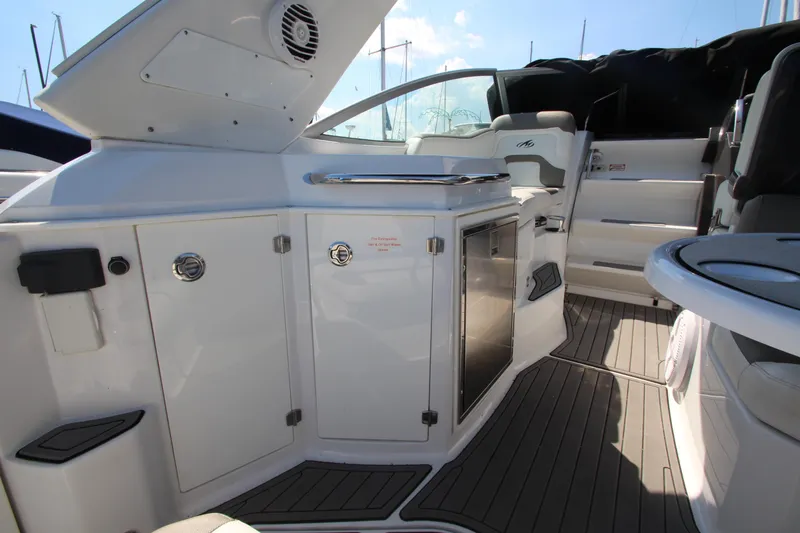 Slide: The Image of 2018 Monterey 295 Sport Yacht interior with sleek cabinetry and modern seating. - 11