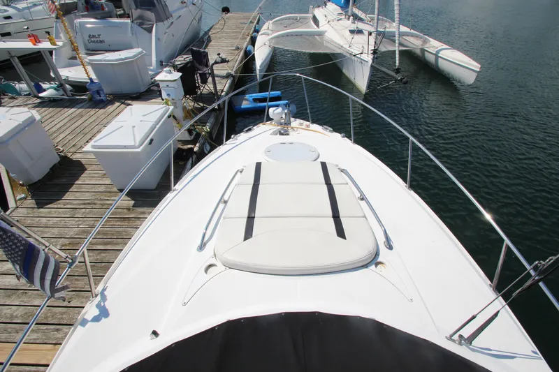 Slide: The Image of 2018 Monterey 295 Sport Yacht docked, showcasing sleek design and spacious deck. - 14