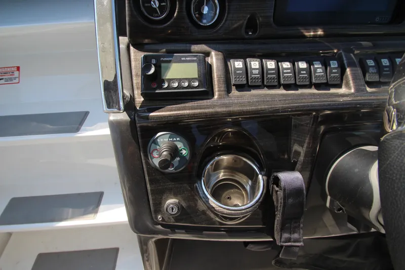 Slide: The Image of Control panel of 2018 Monterey 295 Sport Yacht with switches and cup holder. - 18