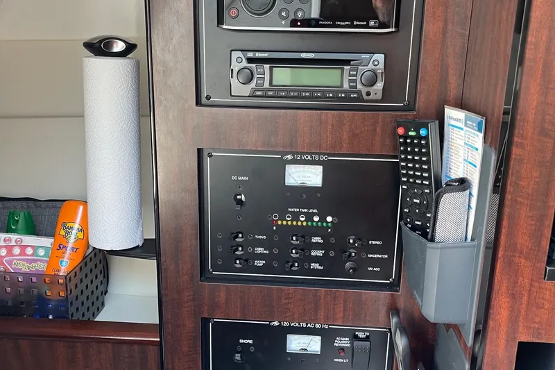 Slide: The Image of Control panel of a 2018 Monterey 295 Sport Yacht with electronics and storage compartments. - 26