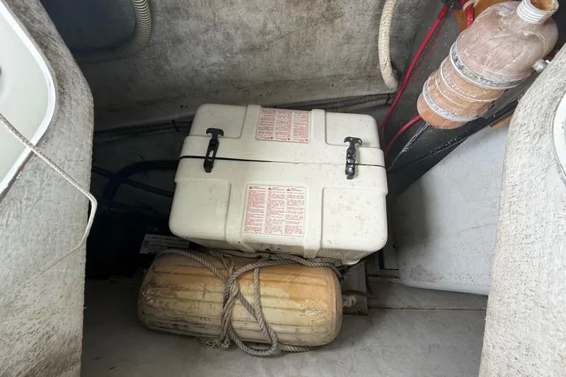 Slide: The Image of Storage compartment of a 2003 Jeanneau Sun Odyssey 37 sailboat with safety equipment. - 101