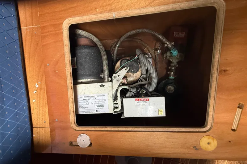 Slide: The Image of Engine compartment of a 2003 Jeanneau Sun Odyssey 37 sailboat, showing mechanical components. - 102