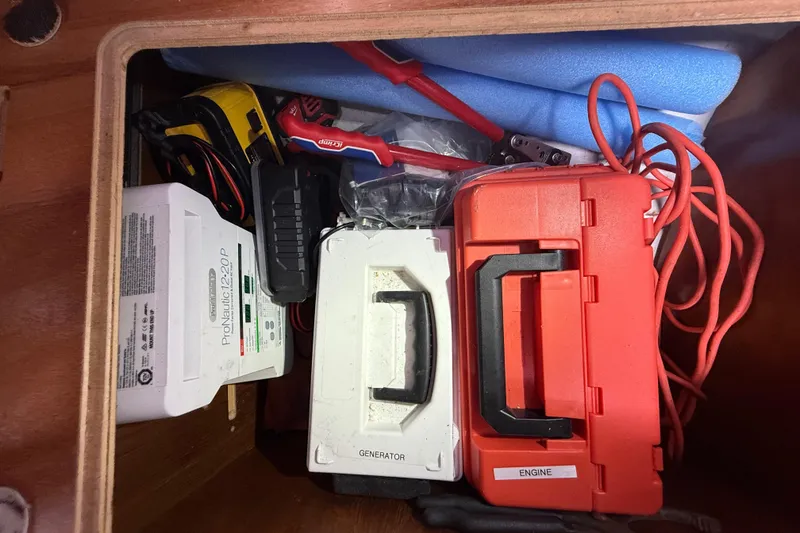 Slide: The Image of Storage compartment on a 2003 Jeanneau Sun Odyssey 37 with tools and equipment. - 103