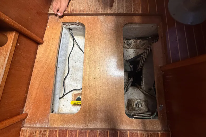 Slide: The Image of Wooden floor panel removed, revealing wiring and compartments on a 2003 Jeanneau Sun Odyssey 37. - 107