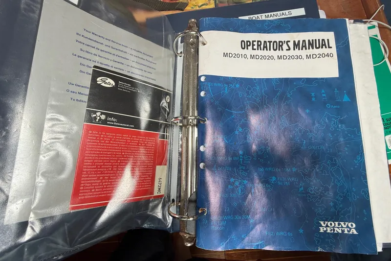 Slide: The Image of Binder with Volvo Penta operator's manual for MD2010, MD2020, MD2030, MD2040 engines. - 115