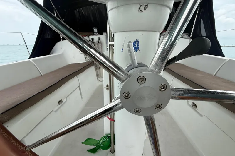 Slide: The Image of Steering wheel of a 2003 Jeanneau Sun Odyssey 37 sailboat, showcasing cockpit details. - 14