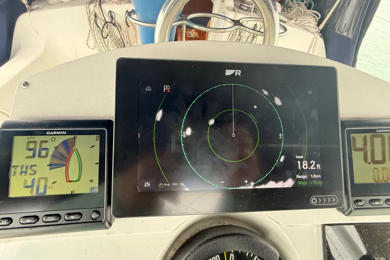 Slide: The Image of Cockpit instruments of a 2003 Jeanneau Sun Odyssey 37 sailboat, displaying navigation data. - 15