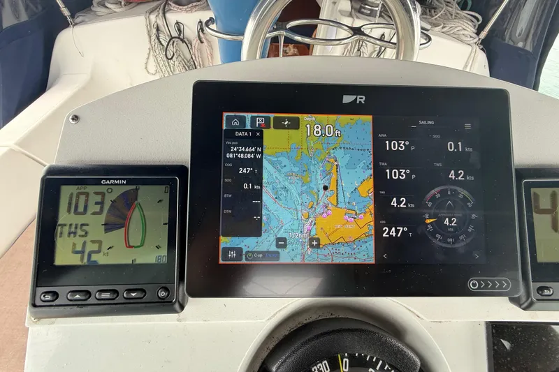 Slide: The Image of Navigation instruments on a 2003 Jeanneau Sun Odyssey 37 sailboat, displaying maps and sailing data. - 16