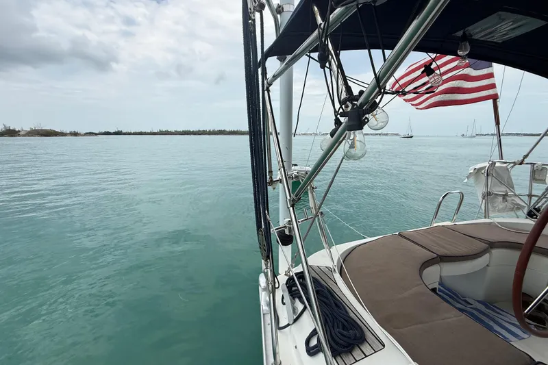 Slide: The Image of Jeanneau Sun Odyssey 37 sailboat on calm waters, 2003 model, with American flag. - 21