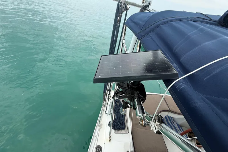 Slide: The Image of Jeanneau Sun Odyssey 37 sailboat with solar panel, 2003 model, on calm water. - 22