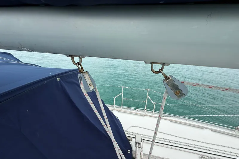 Slide: The Image of Jeanneau Sun Odyssey 37 sailboat deck with rigging and blue cover, 2003 model. - 24