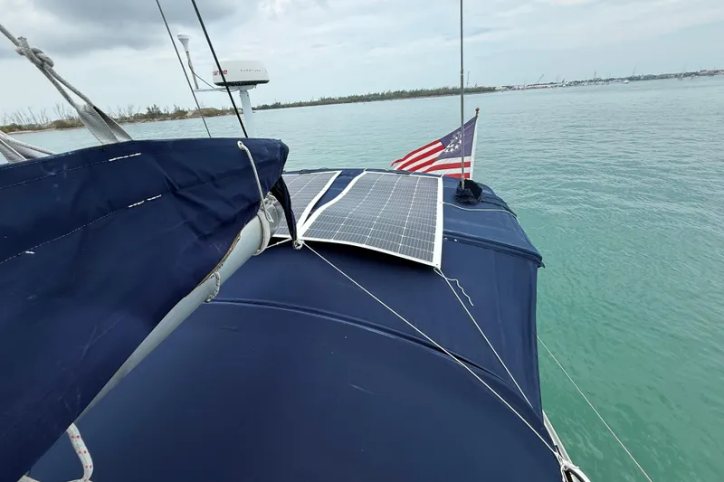 Slide: The Image of 2003 Jeanneau Sun Odyssey 37 sailboat with solar panel and American flag on deck. - 27