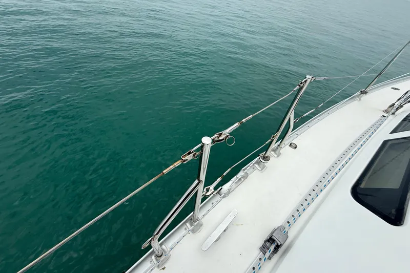 Slide: The Image of Deck view of a 2003 Jeanneau Sun Odyssey 37 sailboat on calm water. - 29