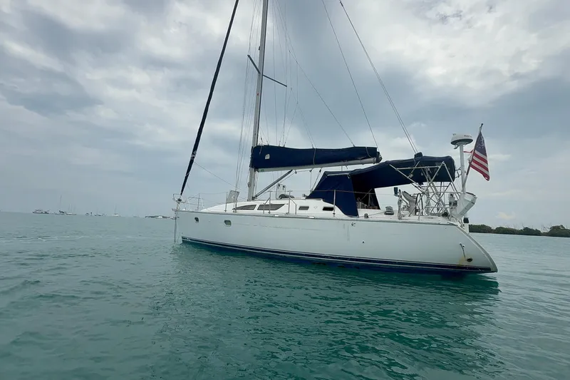 Slide: The Image of 2003 Jeanneau Sun Odyssey 37 sailboat on calm waters under cloudy sky. - 3