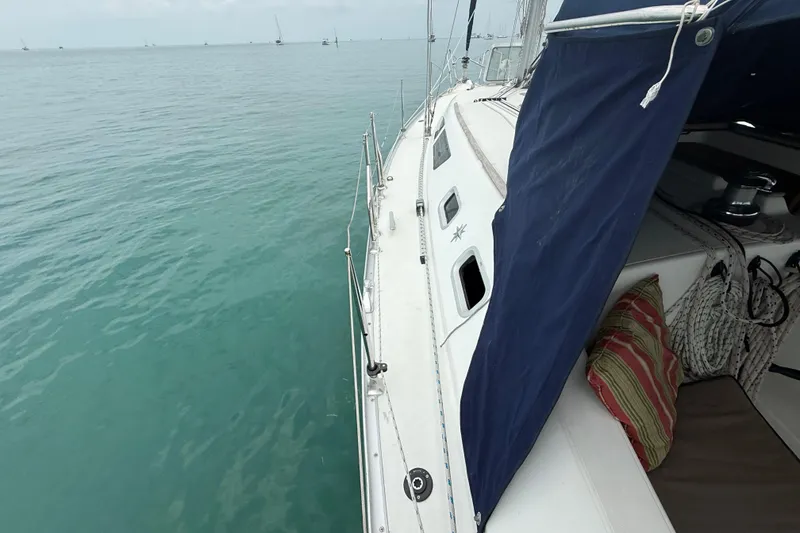 Slide: The Image of 2003 Jeanneau Sun Odyssey 37 sailboat on calm blue water, featuring deck and cabin details. - 30