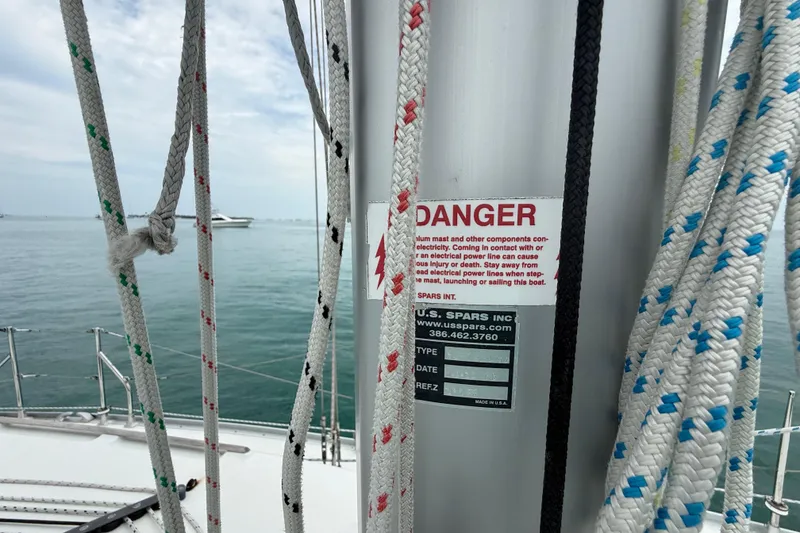 Slide: The Image of Sailboat mast with ropes and warning label, Jeanneau Sun Odyssey 37, 2003 model. - 31