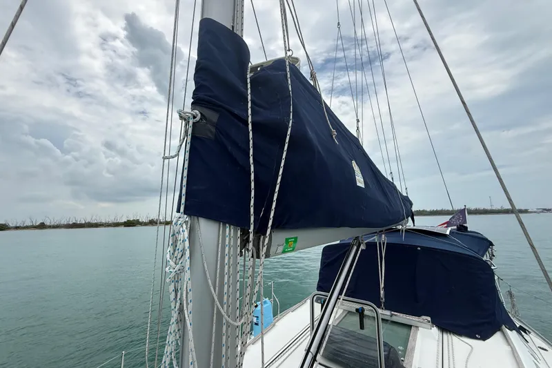 Slide: The Image of 2003 Jeanneau Sun Odyssey 37 sailboat with covered sails on a cloudy day. - 32