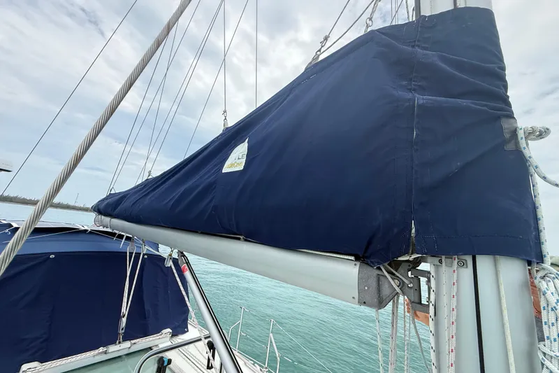Slide: The Image of 2003 Jeanneau Sun Odyssey 37 sailboat with blue sail cover on calm water. - 34