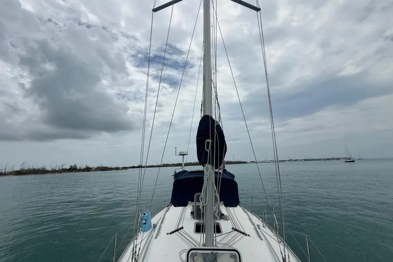 Slide: The Image of 2003 Jeanneau Sun Odyssey 37 sailboat on calm waters under cloudy sky. - 38