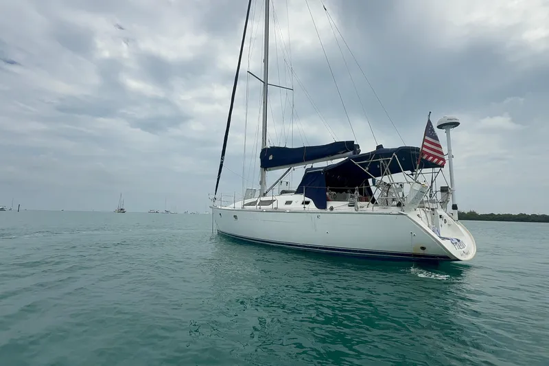 Slide: The Image of 2003 Jeanneau Sun Odyssey 37 sailboat on calm waters under cloudy skies. - 4