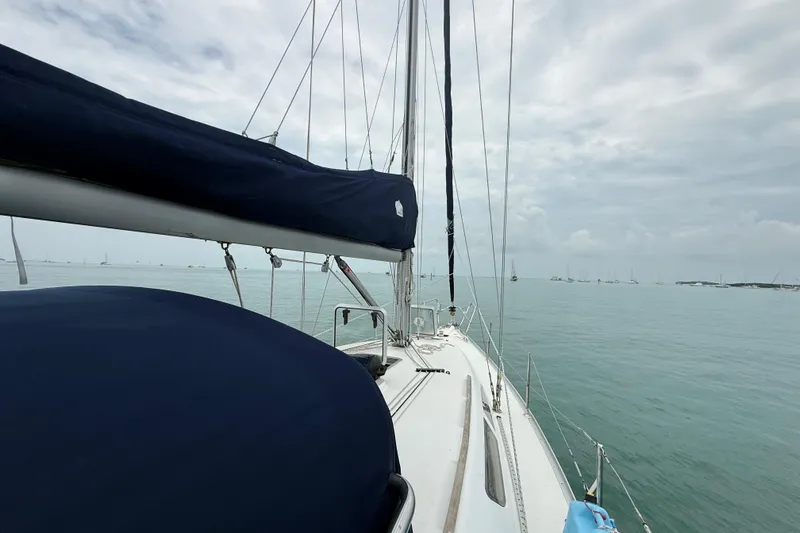 Slide: The Image of 2003 Jeanneau Sun Odyssey 37 sailboat on calm sea under cloudy sky. - 43