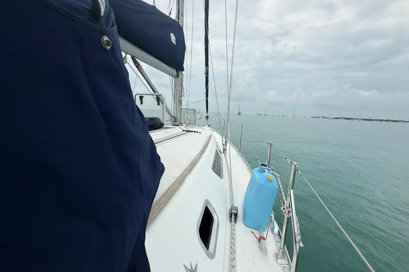 Slide: The Image of 2003 Jeanneau Sun Odyssey 37 sailboat on calm sea with cloudy sky. - 44