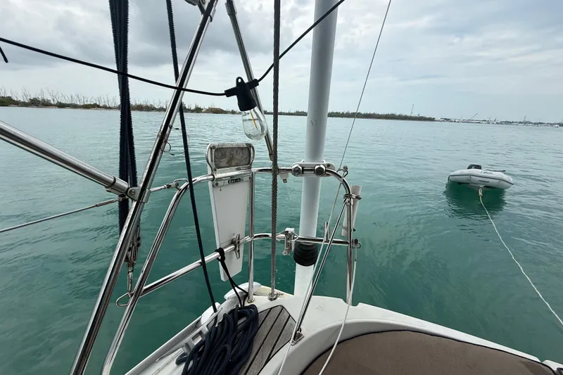 Slide: The Image of Jeanneau Sun Odyssey 37 sailboat deck view with calm sea and dinghy, 2003 model. - 46