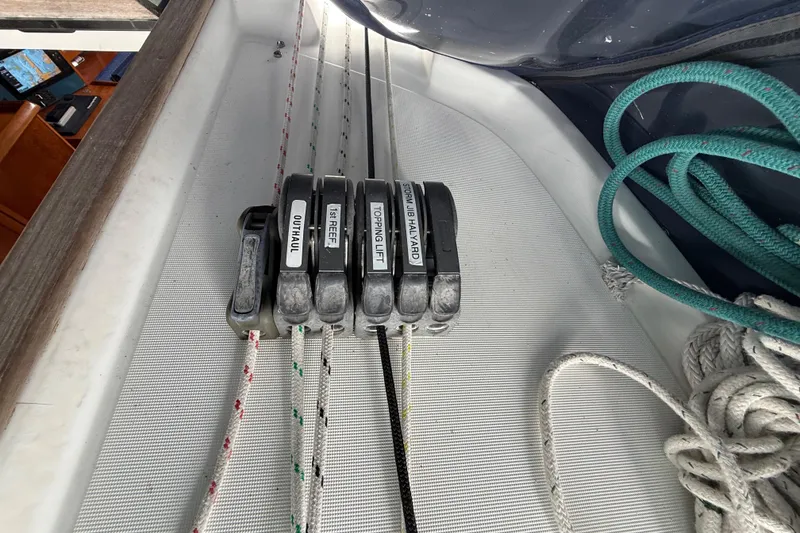 Slide: The Image of Deck rigging on a 2003 Jeanneau Sun Odyssey 37 sailboat, featuring labeled rope clutches. - 54
