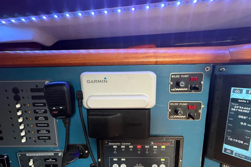 Slide: The Image of Control panel of a 2003 Jeanneau Sun Odyssey 37 with Garmin and bilge pump systems. - 58