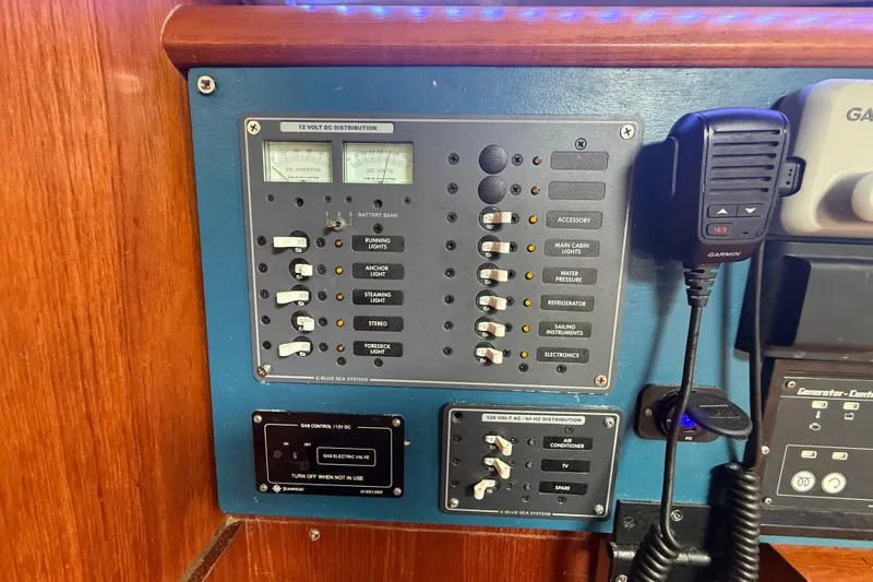 Slide: The Image of Control panel of a 2003 Jeanneau Sun Odyssey 37 sailboat with various switches and gauges. - 59