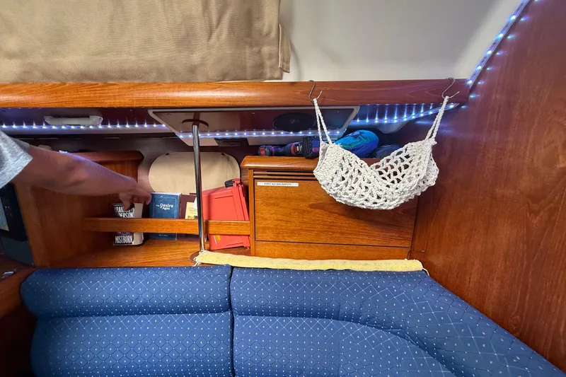 Slide: The Image of Cozy cabin interior of 2003 Jeanneau Sun Odyssey 37 with books and storage. - 61