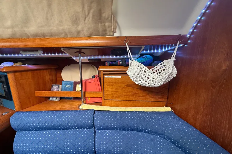 Slide: The Image of Cozy interior of 2003 Jeanneau Sun Odyssey 37 sailboat with books and crochet hammock. - 62