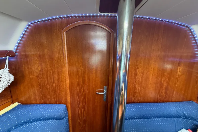 Slide: The Image of Interior of 2003 Jeanneau Sun Odyssey 37 yacht with wood paneling and blue seating. - 63