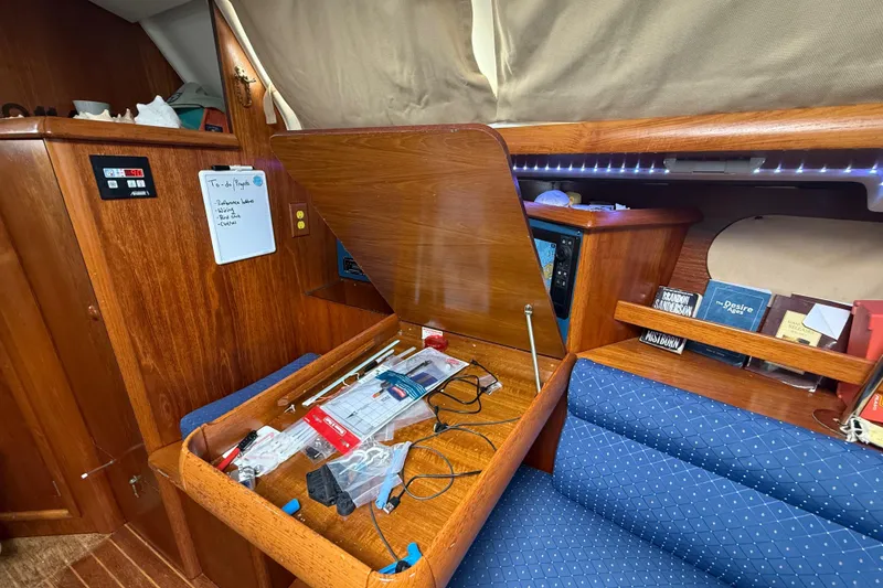 Slide: The Image of Interior of 2003 Jeanneau Sun Odyssey 37 sailboat with wooden cabinetry and blue seating. - 65