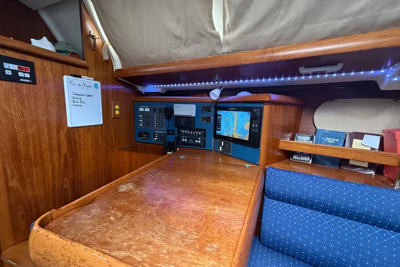 Slide: The Image of Navigation station of 2003 Jeanneau Sun Odyssey 37 sailboat with chart plotter and control panels. - 66