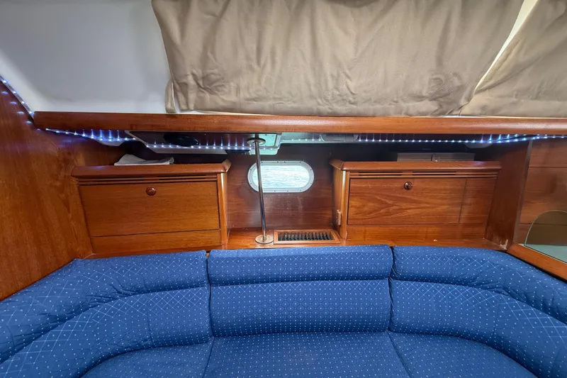 Slide: The Image of Interior of 2003 Jeanneau Sun Odyssey 37 yacht with blue seating and wooden cabinetry. - 69