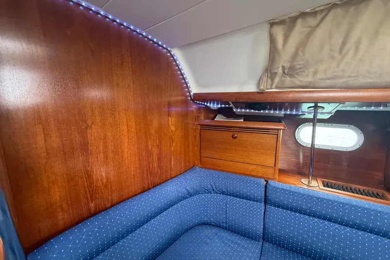 Slide: The Image of Cozy cabin interior of 2003 Jeanneau Sun Odyssey 37 sailboat with blue seating and wood finish. - 70