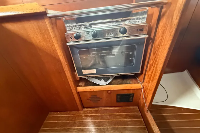 Slide: The Image of Wooden interior of 2003 Jeanneau Sun Odyssey 37 with built-in ENO stove. - 77