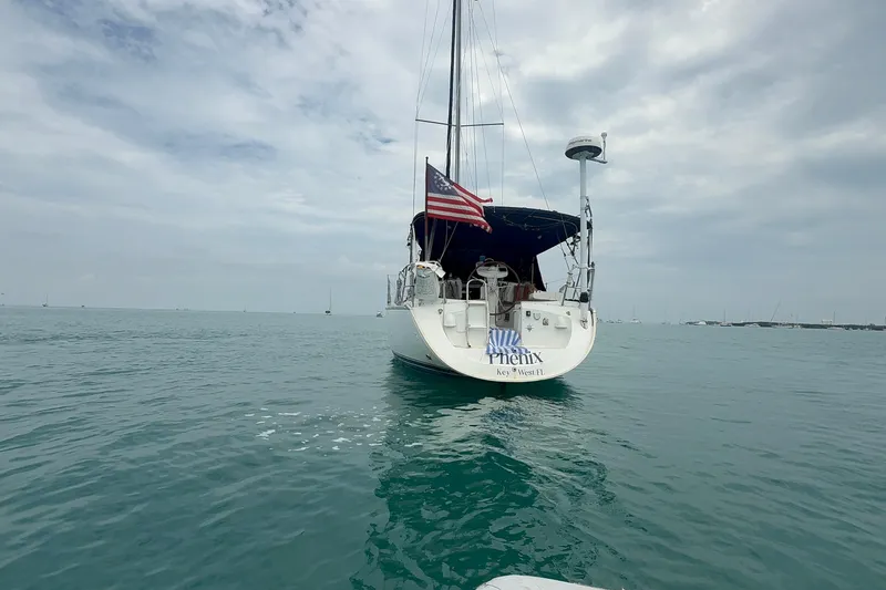 Slide: The Image of 2003 Jeanneau Sun Odyssey 37 sailboat on calm water under cloudy sky. - 8